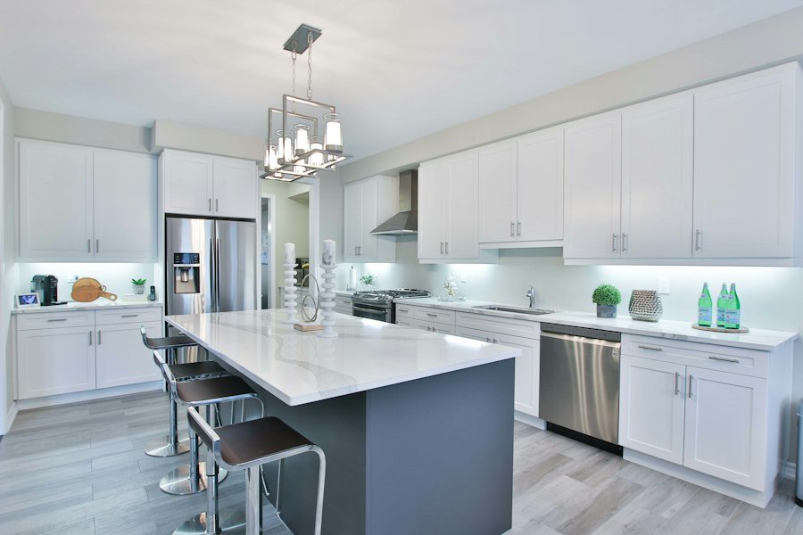 Modern kitchen with white cabinets and a dark island