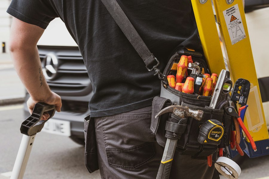 Tradesman holding a yellow and black power tool