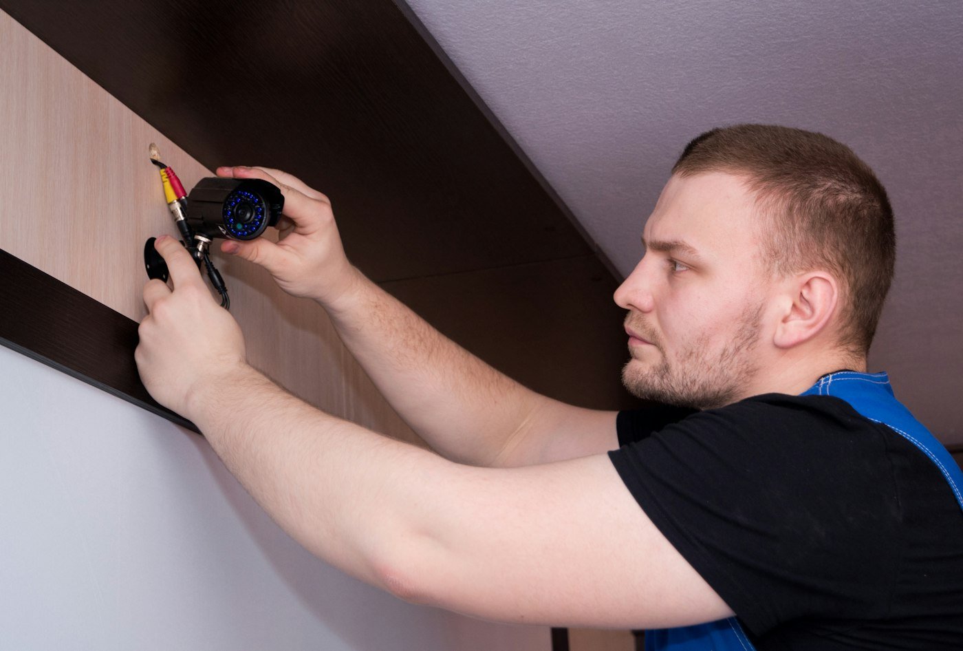 Handyman working on a wall with a screwdriver